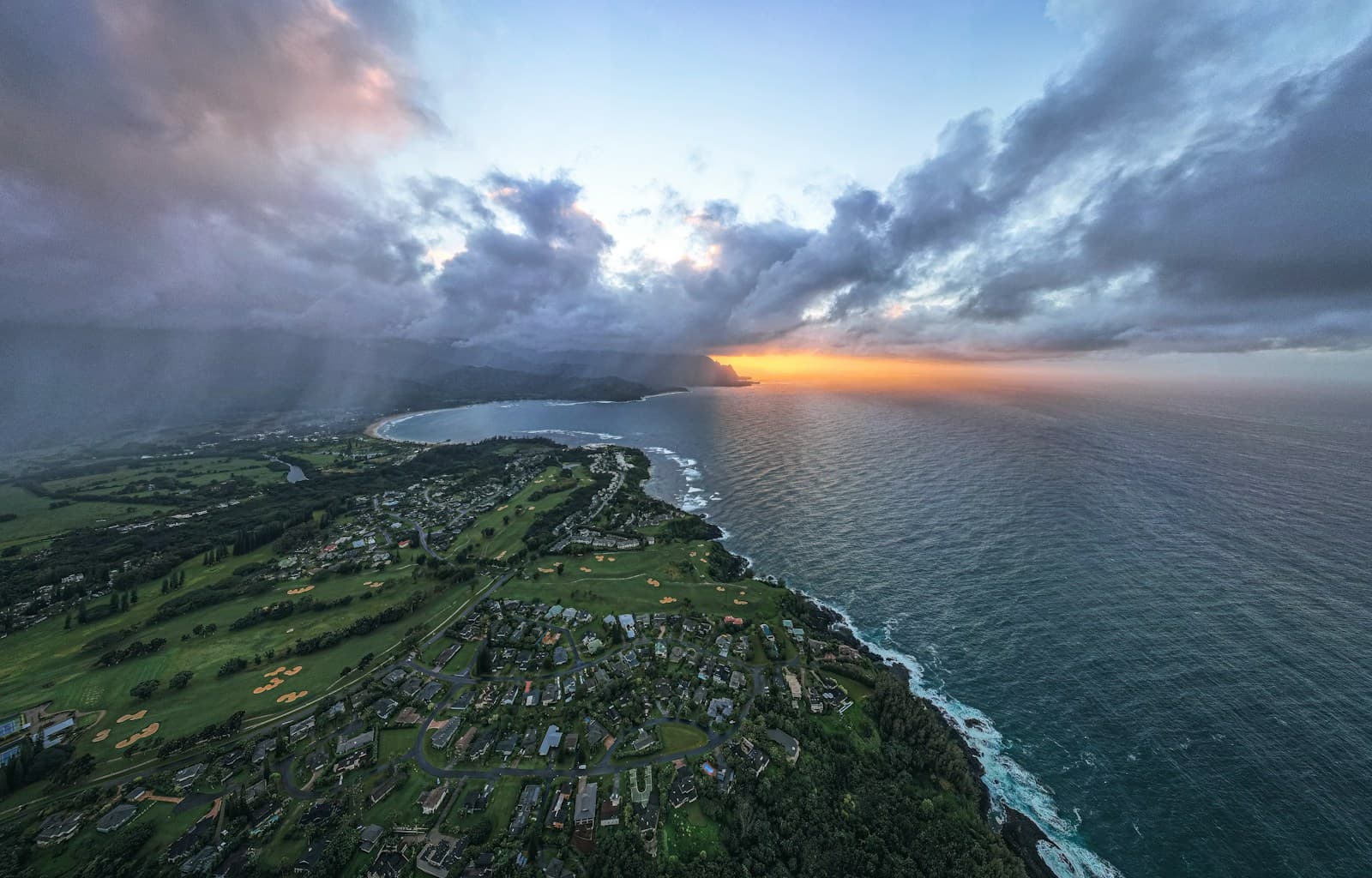 Rolling golf fairways beside the ocean in the soft light of sunset